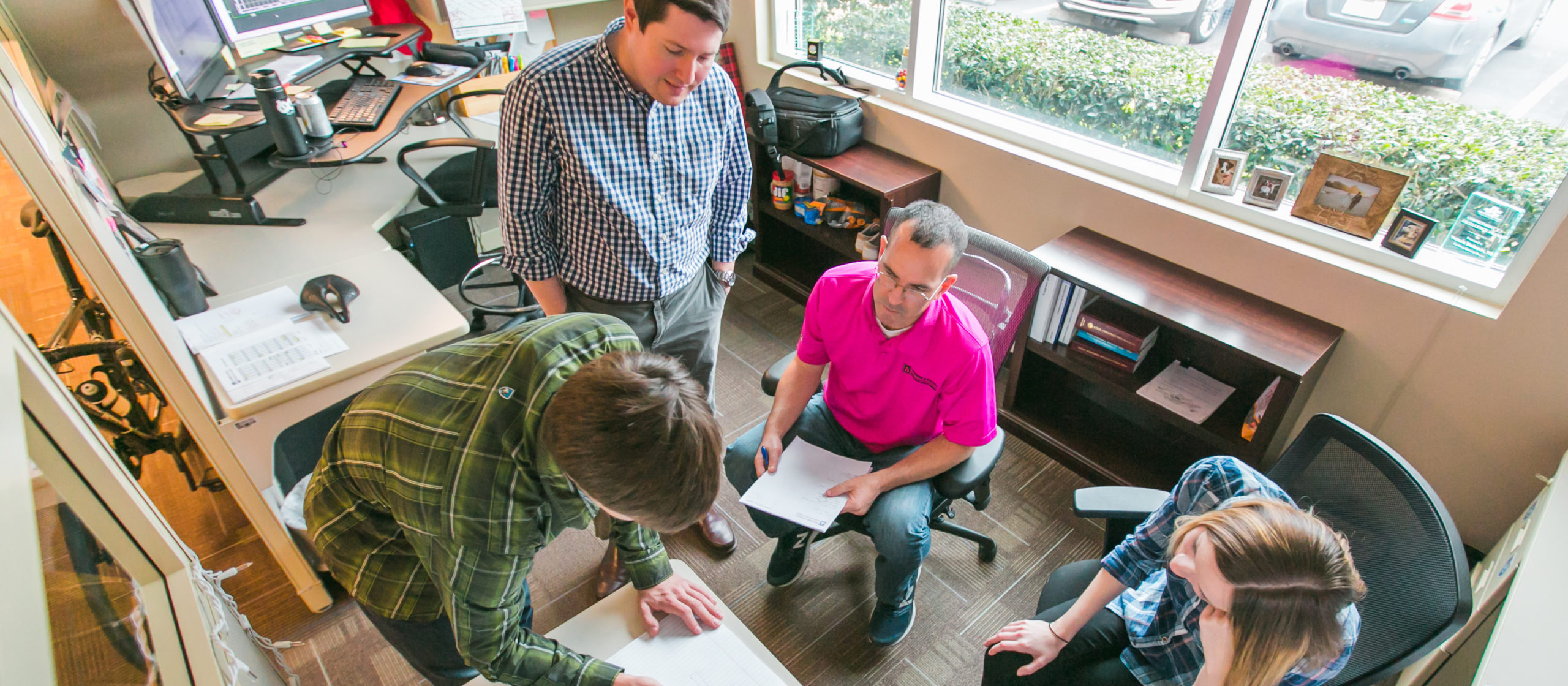 Aguirre & Fields employees discuss project in office