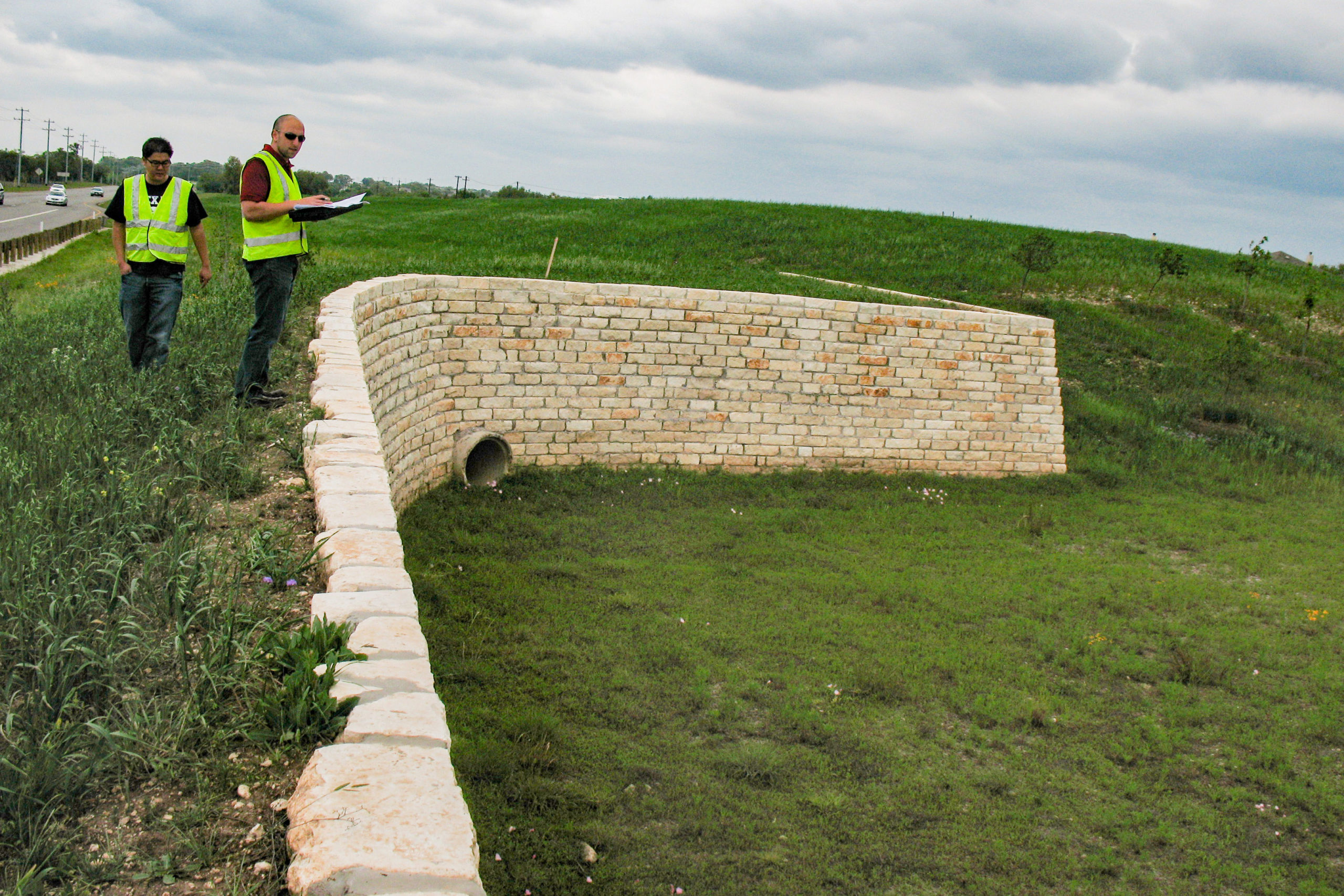 Engineers reviewing retaining wall at US 183A