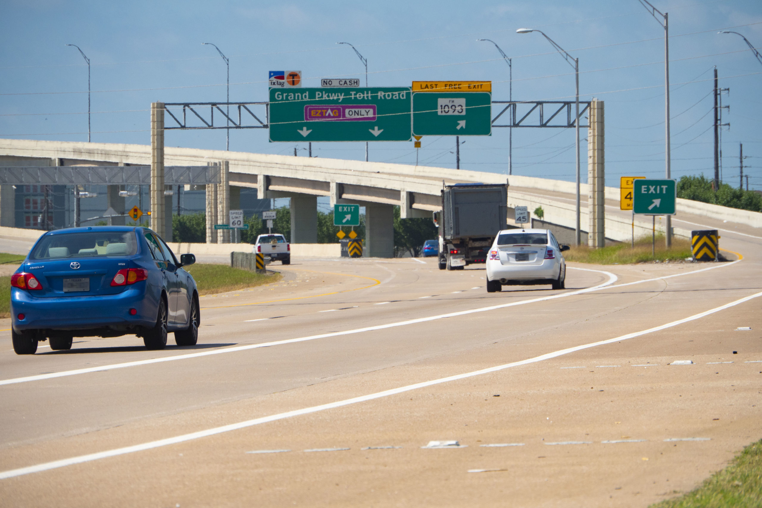 Cars on roads and signage at SH 99 and Westpark Tollway Interchange