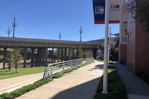 sidewalk with striping between river and retaining wall