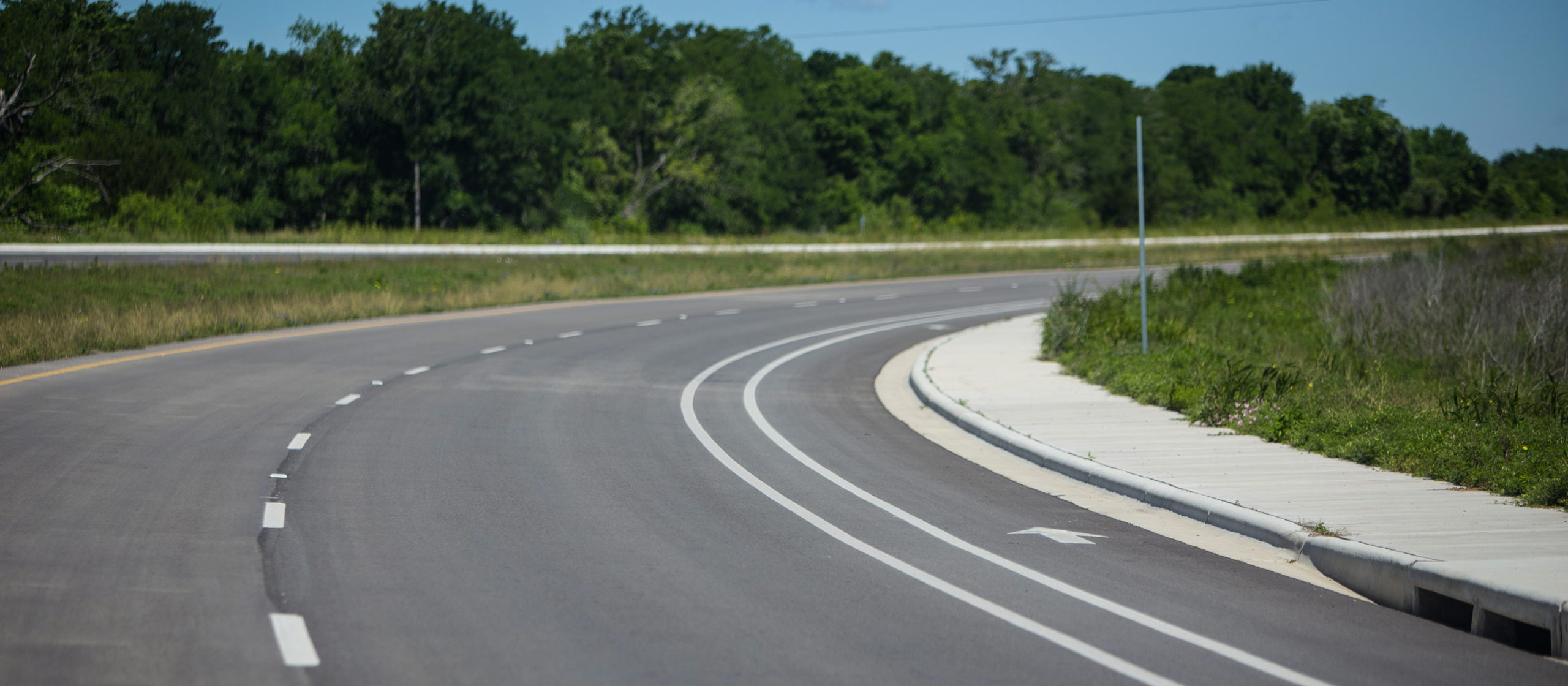 View of curve on road with striping